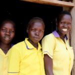 Schoolgirls in South Sudan wait for the cash transfer process to begin.
