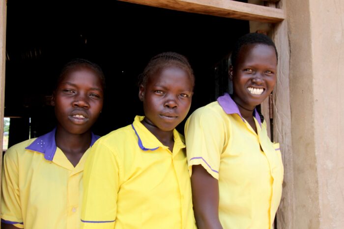 Schoolgirls in South Sudan wait for the cash transfer process to begin.